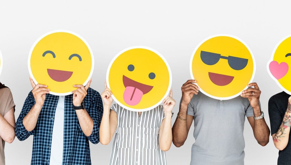 5 people with smiley emojis covering their faces