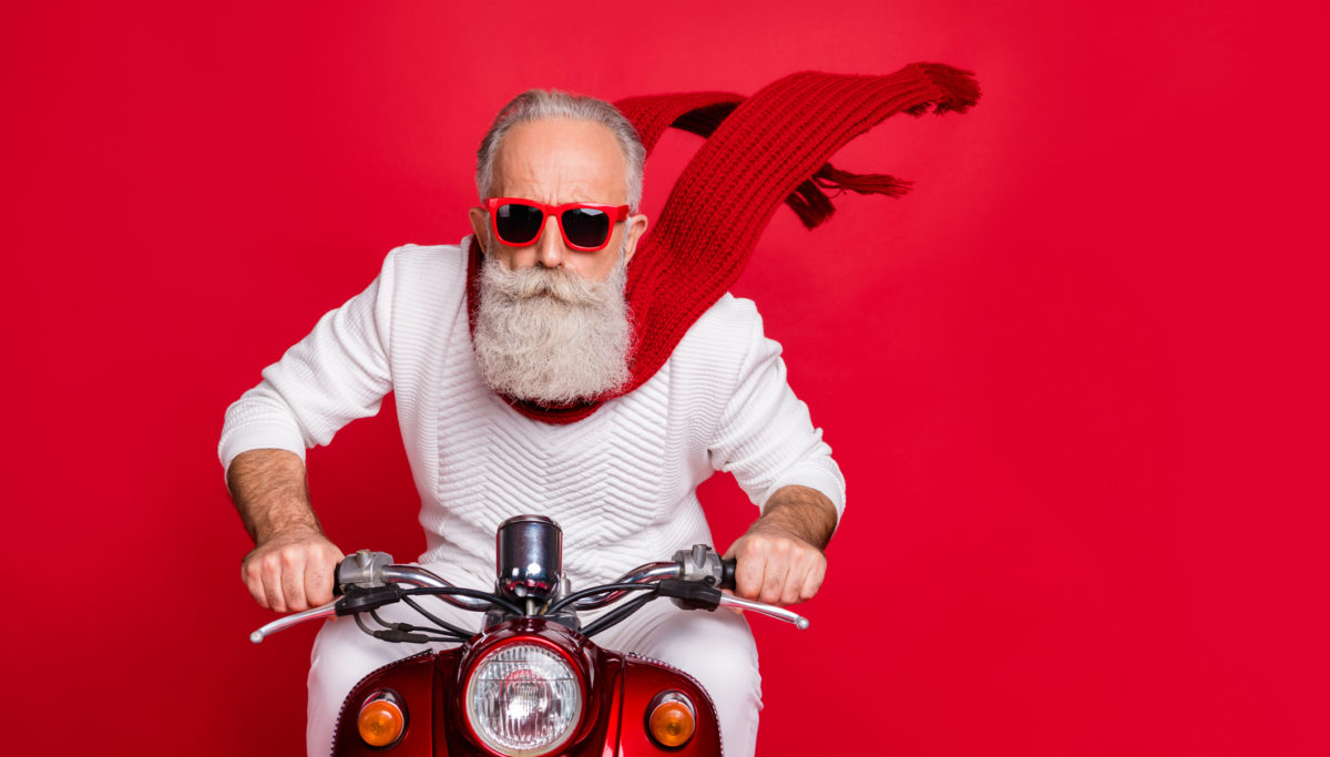 Man riding a his bike on a red background.