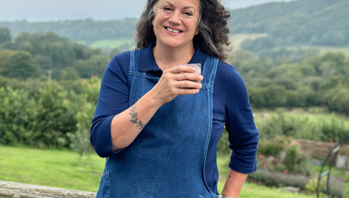 Image of Shann, Chuckling Goat Director, drinking gut health smoothie on farm.